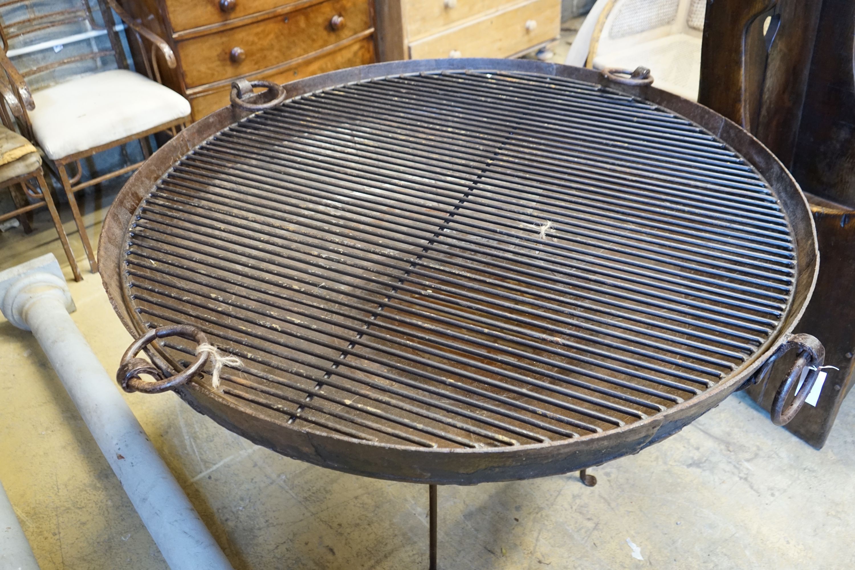 A wrought iron fire pit, diameter 61cm height 57cm